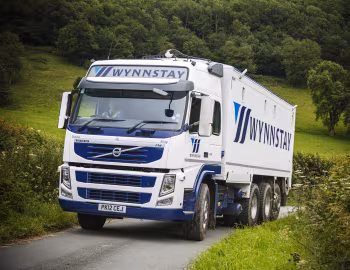 Volvo FM 410 8×4 tridem Globetrotter cab with Priden Engineering tipper body [UK-spec] '2010–13